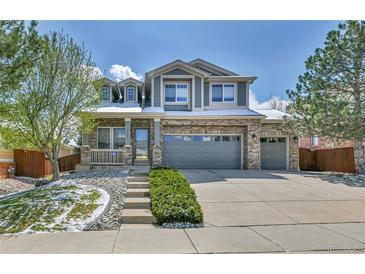 Charming two-story home with brick accents and a three-car garage at 20948 E Hamilton Ave, Aurora, CO 80013