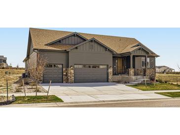 Charming single-Gathering home featuring a two-car garage, covered porch, and stone accents at 23774 E 36Th Pl, Aurora, CO 80019