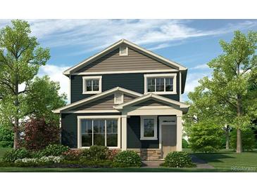 Charming two-story home featuring a beautifully landscaped front yard, enhancing curb appeal and creating a welcoming atmosphere at 673 N Tempe St, Aurora, CO 80018