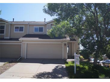Charming townhome with a two-car garage, mature tree, and well-maintained landscaping at 10966 Josephine St, Northglenn, CO 80233