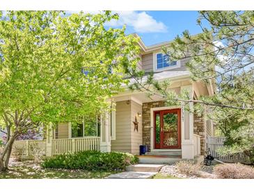 Charming two-story home with a welcoming front porch and beautiful landscaping at 11367 S Blackthorn Ct, Parker, CO 80134