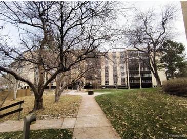 Condo building with green space and a sidewalk at 6960 E Girard Ave # 404, Denver, CO 80224