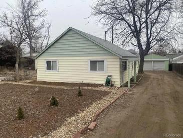 Ranch style home with two-tone siding and a spacious yard at 444 S Jersey St, Denver, CO 80224