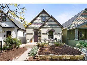 Charming home featuring a front patio, unique architectural details, and a well-maintained yard at 3375 W 37Th Ave, Denver, CO 80211
