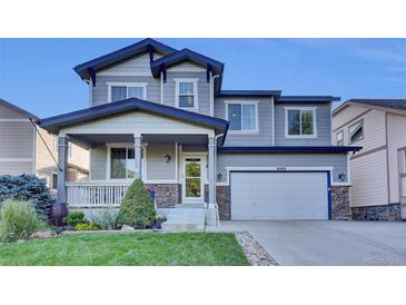 Charming two-story home with a covered front porch and well-maintained landscaping at 8489 S Quay St, Littleton, CO 80128