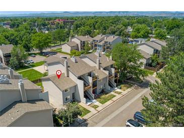 This aerial view captures a multi-Gathering residence with light gray exterior paint in a lush, green neighborhood at 6011 Yarrow St # I, Arvada, CO 80004