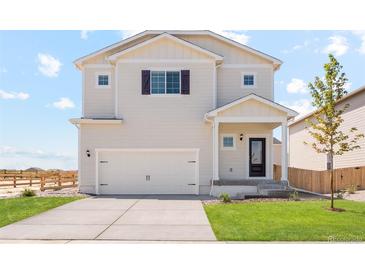 Charming two-story home featuring a two-car garage, well-maintained lawn, and classic architectural details at 7322 Green River Ave, Frederick, CO 80530