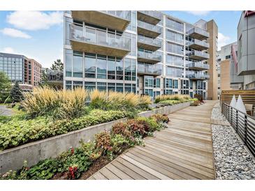 Modern building with landscaped walkway and courtyard at 1620 Little Raven St # 109, Denver, CO 80202