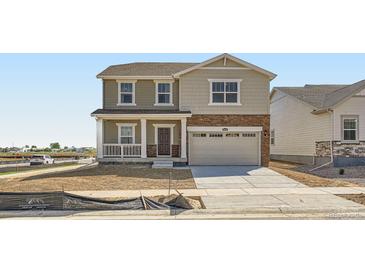 Charming two-story home with a blend of stone and siding, complemented by a well-manicured lawn at 15296 Fillmore St, Thornton, CO 80602
