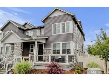 Charming gray two-story home with stone accents and a cozy front porch at 3765 W 88Th Ct, Westminster, CO 80031
