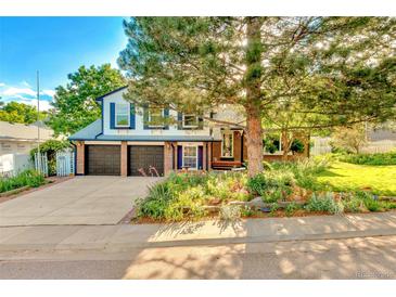 Charming two-story home with a well-manicured lawn and a two car garage showcasing its inviting curb appeal at 7681 S Jellison St, Littleton, CO 80127