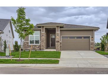 Inviting single-Gathering home featuring a stone-accented facade, lush lawn, and a two-car garage at 3166 Newfound Lake Rd, Berthoud, CO 80513