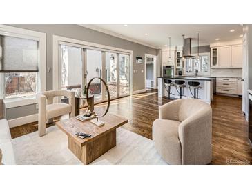 Bright living room boasts hardwood floors, neutral tones, and sliding glass doors to an outdoor patio at 325 S High St, Denver, CO 80209