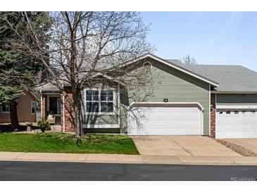 Charming home with a well-maintained lawn and a two-car garage, perfect for suburban living at 33 Canongate Ln, Highlands Ranch, CO 80130