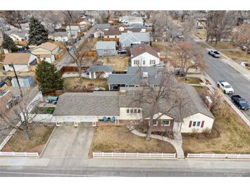 Aerial view of the property showcasing the home, yard, and neighborhood at 8001 W 57Th Ave, Arvada, CO 80002