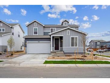 Charming two-story home with a two-car garage and well-manicured lawn in a suburban neighborhood at 1352 Orchard St, Brighton, CO 80601
