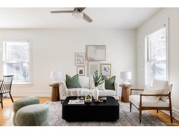 Bright living room featuring a white sofa, stylish decor, and large windows at 1000 N Ogden St, Denver, CO 80218