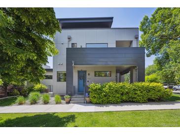 Contemporary home with a blue front door, modern landscaping, and a well-manicured lawn at 2898 W 22Nd Ave, Denver, CO 80211
