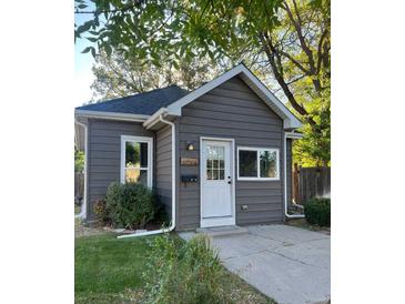 Charming home with gray siding, a white door, and neatly trimmed landscaping adding to its curb appeal at 4344 Chase St, Denver, CO 80212