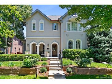 Charming home featuring a landscaped front yard, arched entryway, and decorative windows, showcasing elegant curb appeal at 1164 S High St, Denver, CO 80210