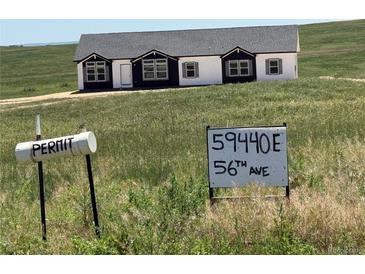 New construction exterior showing black and white paint scheme with sign in the foreground at 59440 E 56Th Ave, Strasburg, CO 80136