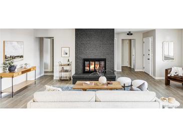 Cozy living room featuring a stylish fireplace, modern furnishings, and neutral tones at 3483 S Race St, Englewood, CO 80113