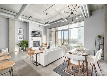 Bright, open living space with polished concrete floors, fireplace, and modern furnishings at 2899 N Speer Blvd # 203, Denver, CO 80211