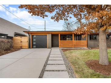 Modern ranch home with attached garage and landscaped front yard at 991 S Holly St, Denver, CO 80246