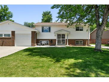 Charming two-story home with a well-maintained front yard and brick accents at 4604 Routt St, Wheat Ridge, CO 80033