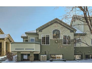 Two-story townhouse showcasing unique architectural design and complemented by a snow-covered landscape, offering a modern and cozy appeal at 4143 Da Vinci Dr, Longmont, CO 80503