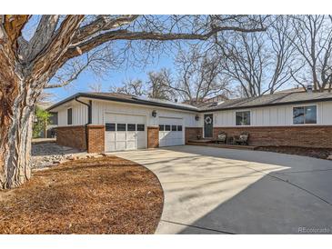 Charming ranch-style home with a circular driveway and attractive brick and white siding at 1740 Shavano St, Longmont, CO 80504