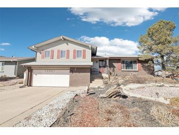 Charming two-story home with red shutters, brick accents, and a well-maintained front yard at 12097 E Mexico Ave, Aurora, CO 80012