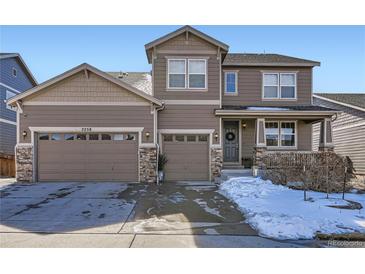 Charming two-story home showcasing a three-car garage and inviting front porch at 7258 Oasis Dr, Castle Rock, CO 80108