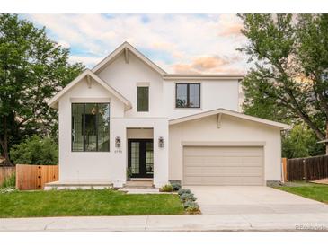 Stunning two-story home features manicured lawn, attached two car garage, and sophisticated design at 2773 S Garfield St, Denver, CO 80210