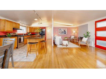 Bright, open-concept living space featuring a modern kitchen and inviting seating area at 2370 S Meade St, Denver, CO 80219