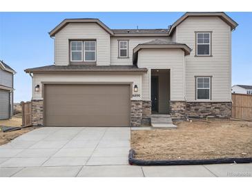 Charming two-story home featuring a two-car garage, stone accents, and neutral-colored siding for a welcoming curb appeal at 16890 Black Rose Pl, Parker, CO 80134