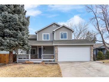 Charming two-story home featuring a stone-accented facade, covered porch, and attached two-car garage at 13124 Tejon St, Westminster, CO 80234