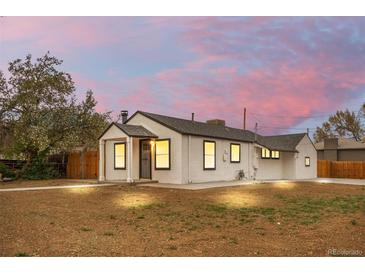 Charming single-story home featuring a cozy front porch, a well-maintained yard, and fresh exterior paint at 2601 W Amherst Ave, Denver, CO 80236
