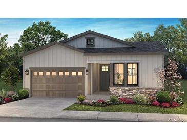 Charming single-story home featuring a stone accent, a two-car garage, and professionally landscaped front yard at 11126 Amber Light Cir, Littleton, CO 80125