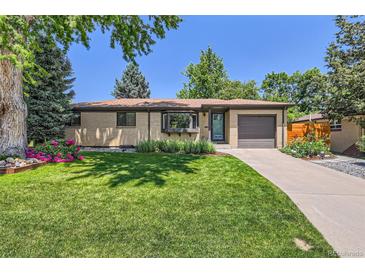 Charming brick ranch-style home with lush green lawn and meticulously landscaped front yard at 5525 E Bails Dr, Denver, CO 80222