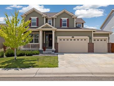Charming two-story home with a well-maintained lawn and a three-car garage at 16341 Clayton St, Thornton, CO 80602