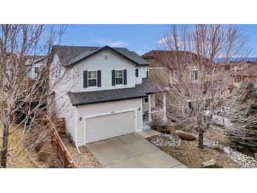 Charming two-story home with a well-manicured lawn, inviting curb appeal, and attached two car garage at 3129 Open Sky Way, Castle Rock, CO 80109
