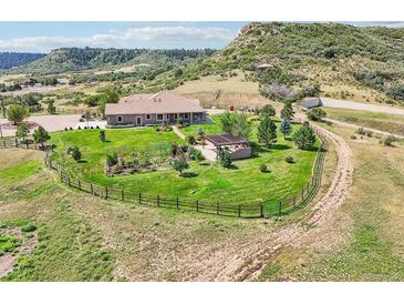Stunning property featuring a sprawling lawn, mature trees, garden, and beautiful outdoor living space at 5285 E State Highway 86, Franktown, CO 80116