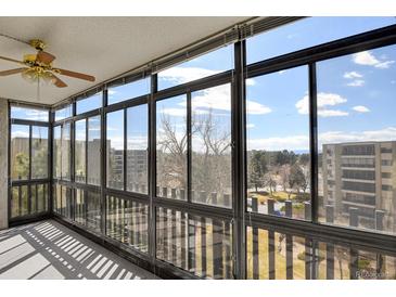 Bright sunroom featuring large windows with picturesque neighborhood views and natural light at 14001 E Marina Dr # 603, Aurora, CO 80014