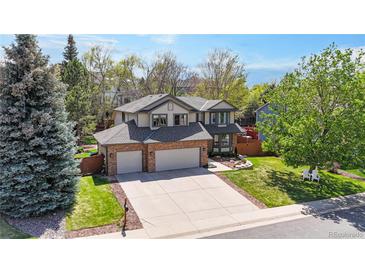 Charming two-story home features a spacious driveway, well-manicured lawn, and beautiful landscaping at 540 Columbine Ave, Broomfield, CO 80020