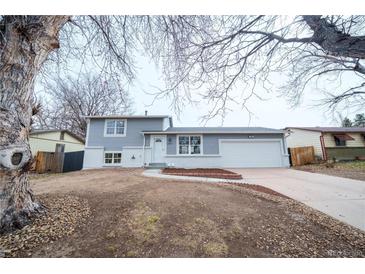 Charming gray two-story home with well-maintained lawn and attached two-car garage at 2880 S Olathe Ct, Aurora, CO 80013