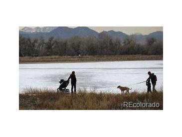 Scenic view of community walking path by water and mountains at 10115 W 25Th Ave # 1, Lakewood, CO 80215