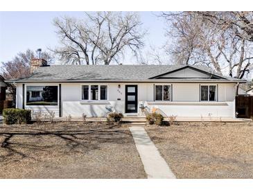 Charming single-story home featuring painted brick, a modern front door and a well-manicured front yard at 965 S Jersey St, Denver, CO 80224