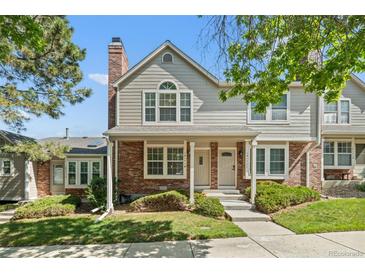 Charming multi-level townhouse featuring a brick and siding facade with well-manicured landscaping at 18171 E Arizona Ave # B, Aurora, CO 80017