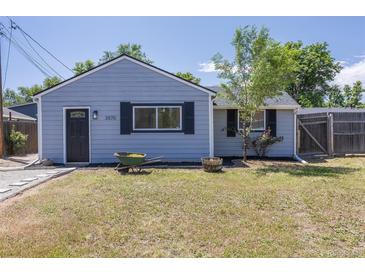 Charming light-blue home with tidy front yard, black shutters and a wheelbarrow at 3570 Center Ave, Denver, CO 80219